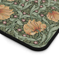 Floral patterned William Morris Pimpernel mouse pad with orange flowers and green leaves on a white background