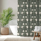 Bathroom with a William Morris shower curtain in deep sage green Pimpernel patten , a tropical plant, and bathtub.