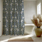 Boho bathroom with a William Morris Pimpernel shower curtain, white bathtub, and decorative vase with pampas grass.