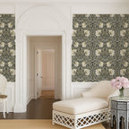William Morris Pimpernel wallpaper in Sage & Cream on Ebony styled in an elegant hallway with arched doorway.
