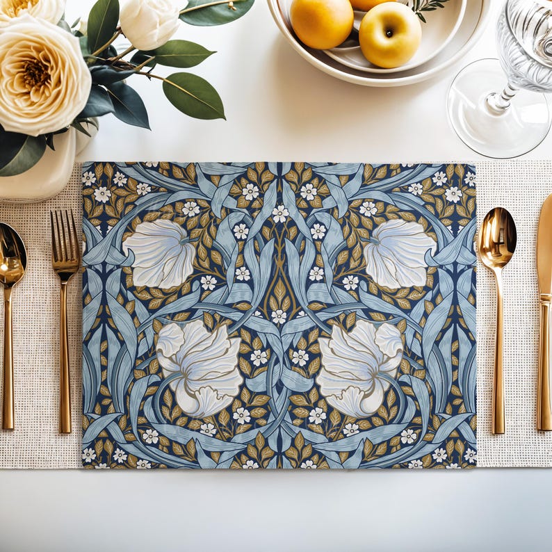 William Morris Pimpernel placemat in Dusty Blue styled on a dining table with florals and place setting