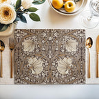 William Morris Pimpernel placemat in Rich Cocoa styled on a dining table with florals and place setting