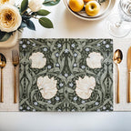 William Morris Pimpernel placemat in Green styled on a dining table with florals and place setting