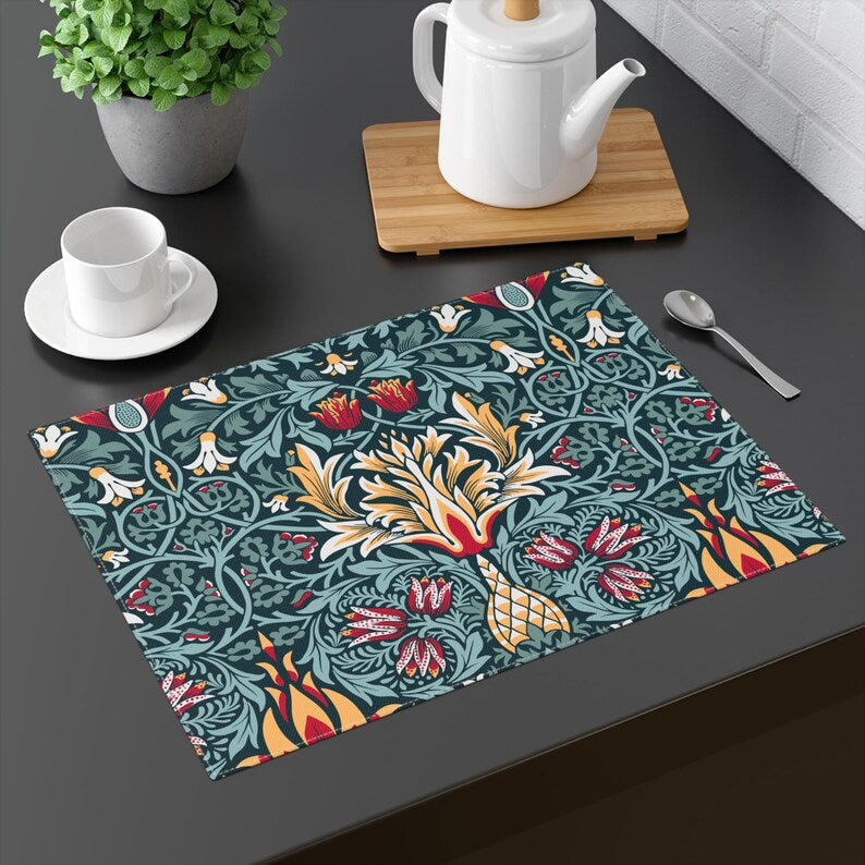 William Morris Snakeshead placemat in Teal & Garnet set on a dining table with tableware.