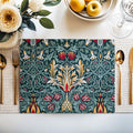 William Morris Snakeshead placemat in Teal & Garnet styled on a dining table with florals and a place setting.