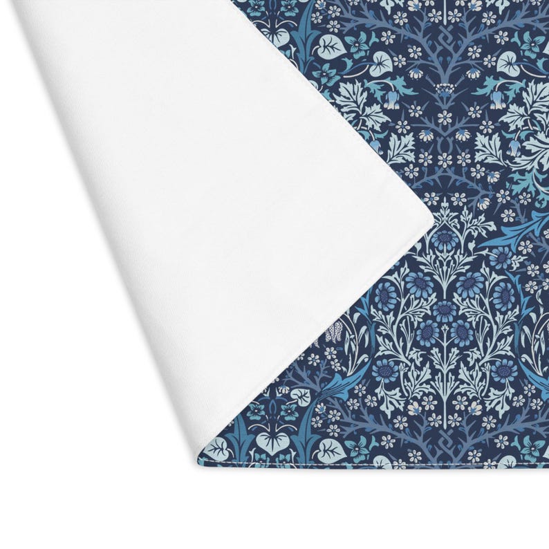 William Morris Blackthorn placemat in Blue styled with floral accents on table