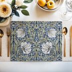 William Morris Pimpernel placemat in Navy and Sage styled on a dining table with florals and place setting
