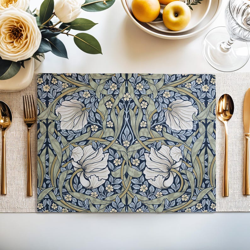 William Morris Pimpernel placemat in Navy and Sage styled on a dining table with florals and place setting