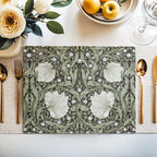 William Morris Pimpernel placemat in Sage Green styled on a dining table with florals and place setting