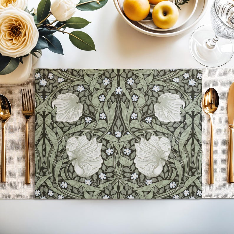 William Morris Pimpernel placemat in Sage Green styled on a dining table with florals and place setting