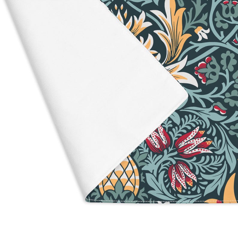 William Morris Snakeshead placemat in Teal & Garnet, detail of the hemmed edge and cotton twill texture.