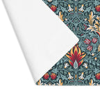 William Morris Snakeshead placemat in Teal & Garnet styled with floral accents on a table.