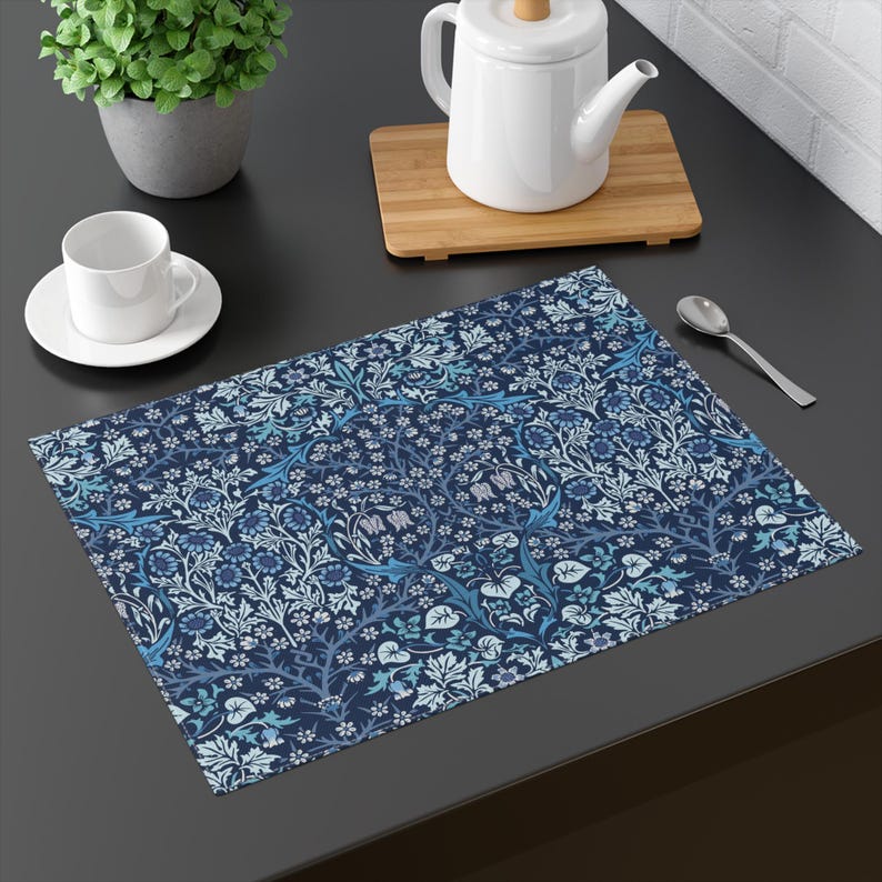William Morris Blackthorn placemat in Blue set on a dining table with tableware