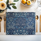 William Morris Blackthorn placemat in Blue styled on a dining table with florals and place setting