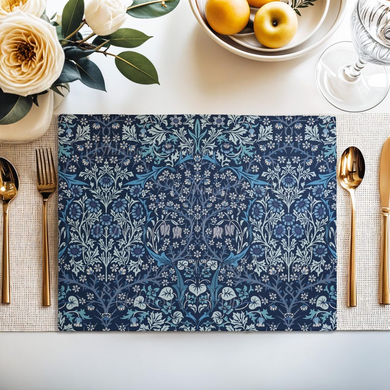William Morris Blackthorn placemat in Blue styled on a dining table with florals and place setting