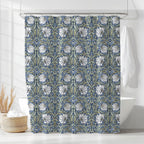 William Morris Pimpernel shower curtain in Blue & Sage 2143, cream tulips and sage-green leaves on a deep navy ground, styled in a bathroom. A handmade extra long cotton sateen shower curtain in 84, 96 and 108 inch lengths.